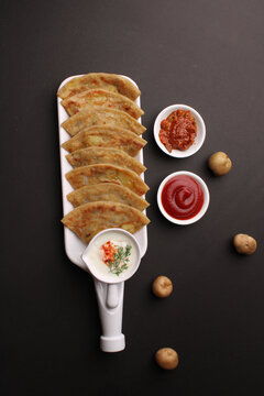 Traditional Indian food Aloo paratha or potato stuffed flat bread. served with pickle  tomato ketchup and curd, butter, onion chili.