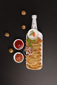 Traditional Indian food Aloo paratha or potato stuffed flat bread. served with pickle  tomato ketchup and curd, butter, onion chili.