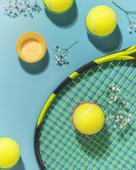 Zelfklevend Fotobehang Holliday sport composition with yellow tennis balls and racket on a blue background of hard tennis court. Sport and healthy lifestyle. The concept of outdoor game sports. Flat lay © KRISTINA KUPTSEVICH