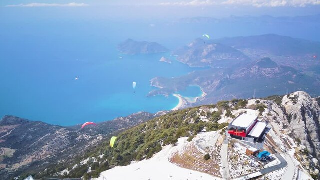 Amazing high angle top drone view on world famous paragliding and parasailing turkish spot for extrim parachute sport in Oludeniz in Fethiye, Turkey