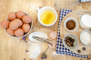 Top View Baking Preparation on wooden Table,Baking ingredients. Bowl, eggs and flour, rolling pin and eggshells on wooden board,Baking concept