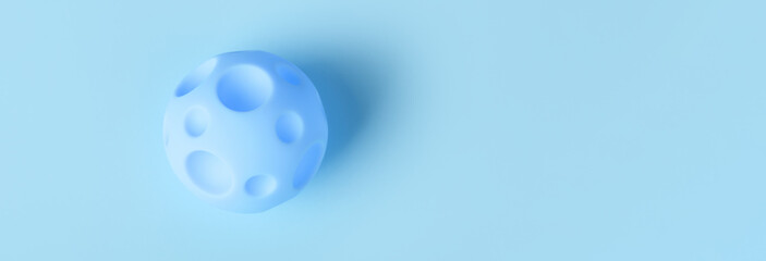toy blue ball with craters on a blue background, the concept of relocation to other planets, panoramic mock-up