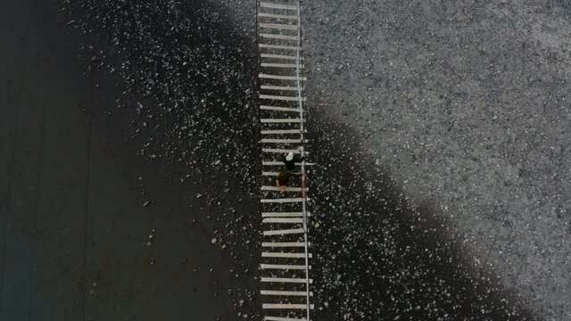 Top View Of Local Women Crossing The Suspension Bridge Of Hussaini In Passu, Hunza Valley, Pakistan. - Aerial Tracking Shot