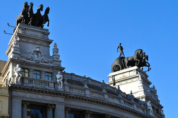 Architecture of the Bilbao Bank building with chariots on the roof in Madrid, Spain.