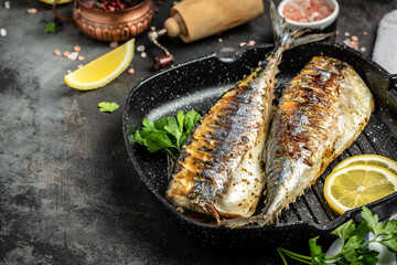 baked mackerel fish in a pan with lemon herbs and spices, banner, menu recipe place for text, top view