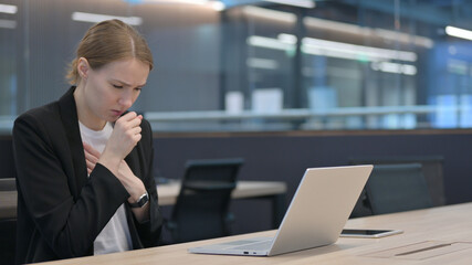 Fototapeta premium Businesswoman Coughing while using Laptop at Work 