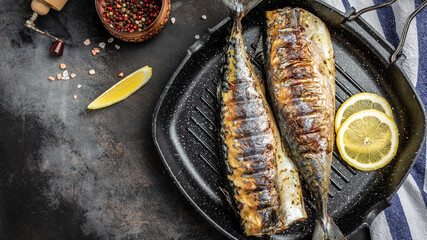 baked mackerel fish in a pan with lemon herbs and spices, banner, menu recipe place for text, top view