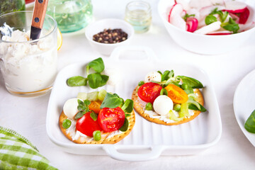 Round crispbread toast with greens and vegetables. Healthy food concept.