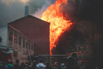 Massive large blaze fire in the city, brick factory building on fire, hell major fire explosion...