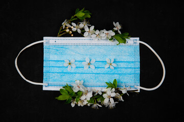 medical mask in spring flowers