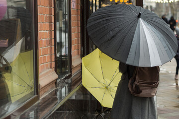 A woman with an umbrella in the pouring rain.