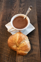 Croissant Rests of Saucer with Cup of Hot Chocolate