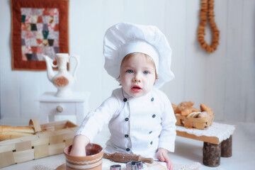 portrait of a little girl in baker clothes. choice of future profession