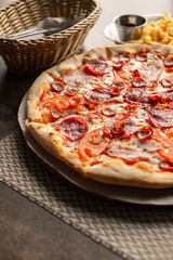 Pizza on the table with dishes and oils and french fries, Italian cuisine. Fried french fries. restaurant service. Food.