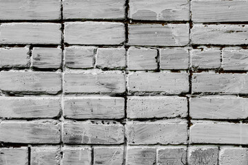 Texture of a brick wall with cracks and scratches which can be used as a background