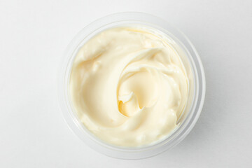 Fototapeta na wymiar Top view on a cup of mayonnaise on white background