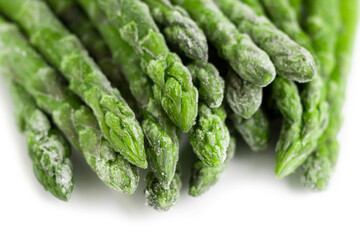 Frozen asparagus on a white plate. Healthy food.
