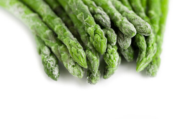 Frozen asparagus on a white plate. Healthy food.