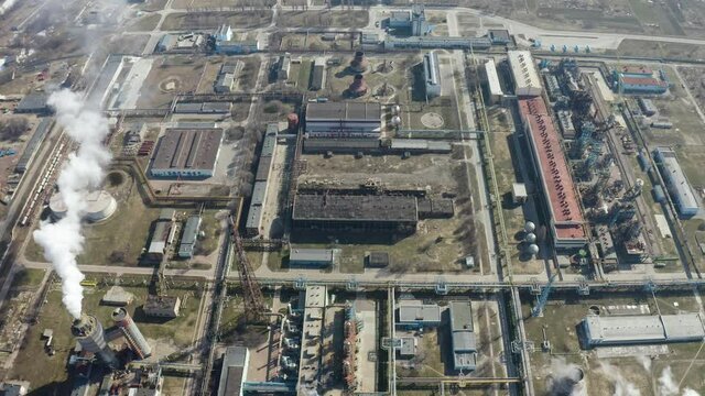 Aerial view of large oil refinery facilities. Plant factory of petrochemical industry and chemical manufacturing. Fuel and power resources. Shot from drone. Industrial factory aerial