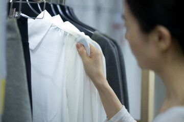 Woman arranging wardrobe at home