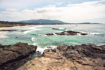 The Pacific Ocean coast in the city of Monterey in California. United States of America. Beautiful beach on a sunny day. Ocean landscape.
