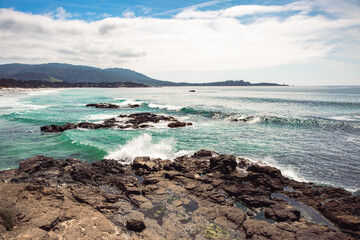 The Pacific Ocean coast in the city of Monterey in California. United States of America. Beautiful beach on a sunny day. Ocean landscape.