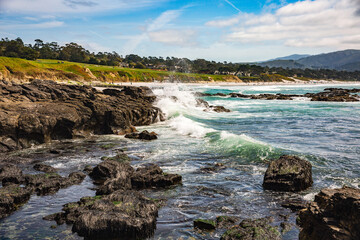 Fototapeta na wymiar The Pacific Ocean coast in the city of Monterey in California. United States of America. Beautiful beach on a sunny day. Ocean landscape.