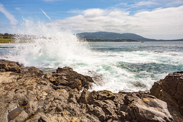 The Pacific Ocean coast in the city of Monterey in California. United States of America. Beautiful beach on a sunny day. Ocean landscape.