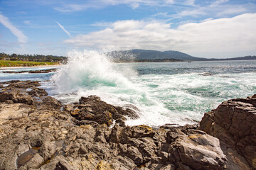 The Pacific Ocean coast in the city of Monterey in California. United States of America. Beautiful beach on a sunny day. Ocean landscape.