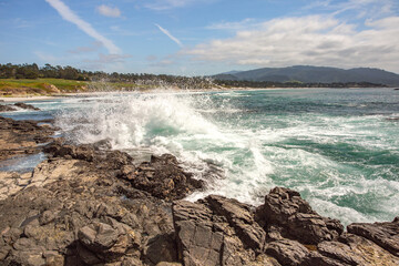 The Pacific Ocean coast in the city of Monterey in California. United States of America. Beautiful beach on a sunny day. Ocean landscape.