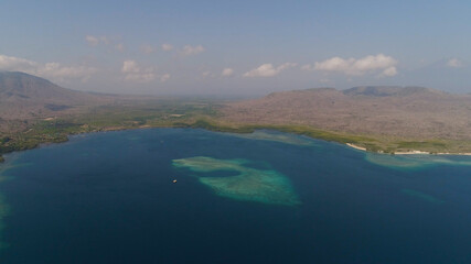 aerial view coastline with beach and coral reef coral reef. seascape atoll with bay turquoise water in sea.Tropical coral reef in ocean waters. Travel concept.