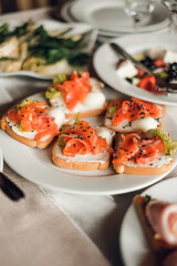 bruschettas with salmon and herbs in a plate on the table