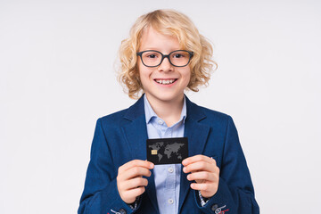 Young caucasian preteen boy holding credit card in formal clothes isolated on white background