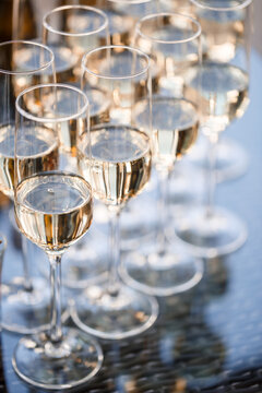 Glass goblets filled with sparkling champagne and stand on the table