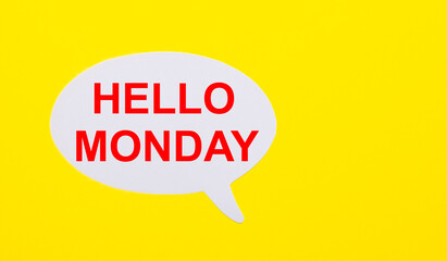 On a bright yellow background, white paper with the words HELLO MONDAY