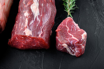 Tenderloin, or Eye Fillet cut raw marbled beef meat, on black stone background