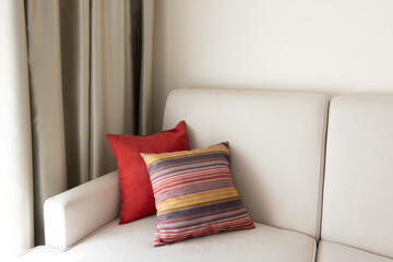 Interior design with couch and colorful cushions. Modern living room interior details. New home