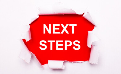 Torn white paper lies on a red background. On red, the text is white NEXT STEPS