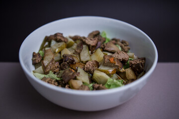 pear with chicken liver in a salad in the kitchen
