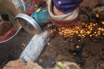 a man in working form is working on production, factory physical labor, a man is holding a...