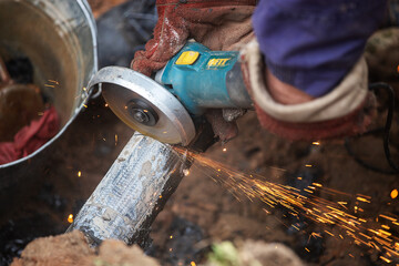 a man in working form is working on production, factory physical labor, a man is holding a...