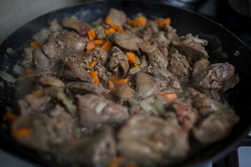 fried liver in a skillet in the kitchen