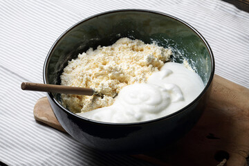 Homemade casserole mix: cottage cheese and beaten egg whites in a ceramic bowl