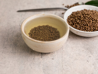Top view of healthy soba tea and groats of tartary buckwheat  Ku Qiao seeds on light background. Flat lay. Copy space