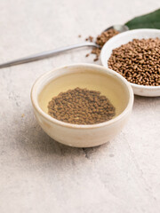 Top view of healthy soba tea and groats of tartary buckwheat  Ku Qiao seeds on light background. Flat lay. Copy space