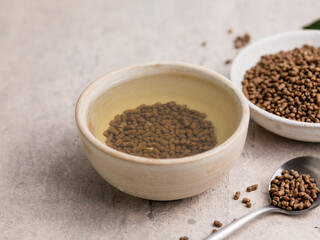 Top view of healthy soba tea and groats of tartary buckwheat  Ku Qiao seeds on light background. Flat lay. Copy space
