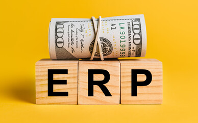 ERP with money on a yellow background. The concept of business, finance, credit, income, savings, investments, exchange, tax