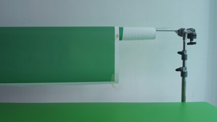 Small set of green screen background in studio. Green screen backdrop and packshot table for video...