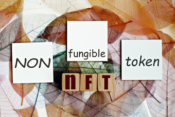 photo on nft (non-fungible token) theme. wooden cubes with the acronym 