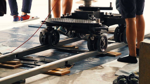 Dolly. Film production Dolly track. Production crew team setting dolly track. dolly car for shooting movie in studio. Wheel track for video camera.